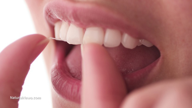 Woman-Floss-Teeth-Close-up