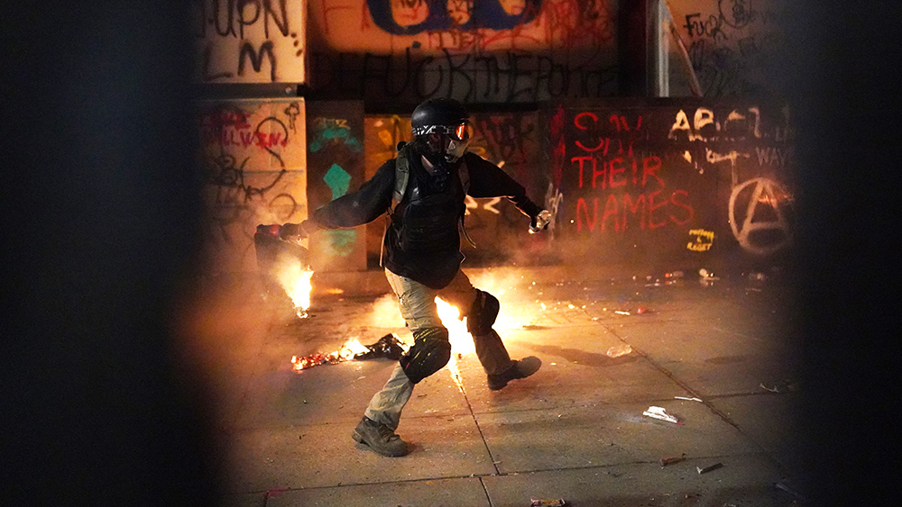 Image: Antifa throws Molotov cocktails at police during a riot in Portland